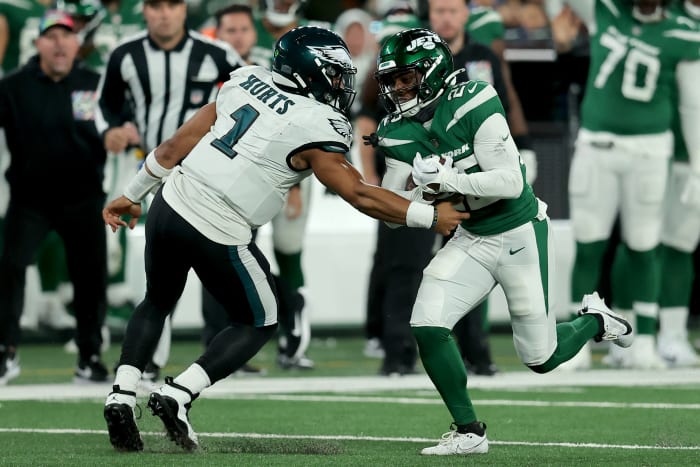 New York Jets safety Tony Adams (22) runs back an interception against Philadelphia Eagles quarterback Jalen Hurts (1) during the fourth quarter at MetLife Stadium.